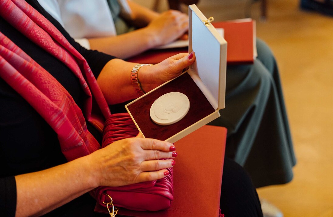 Annen-Medaille 2025: Preisträgerin öffnet Schachtel mit Annen-Medaille